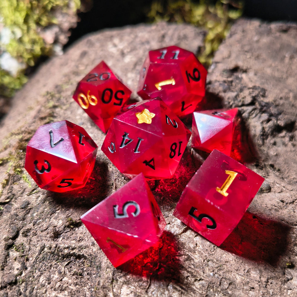 Set of red polyhedral dice on a wood surface