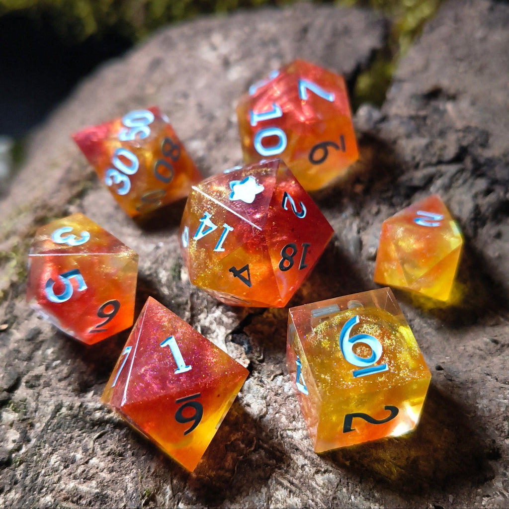 Set of fiery polyhedral dice on a wood surface
