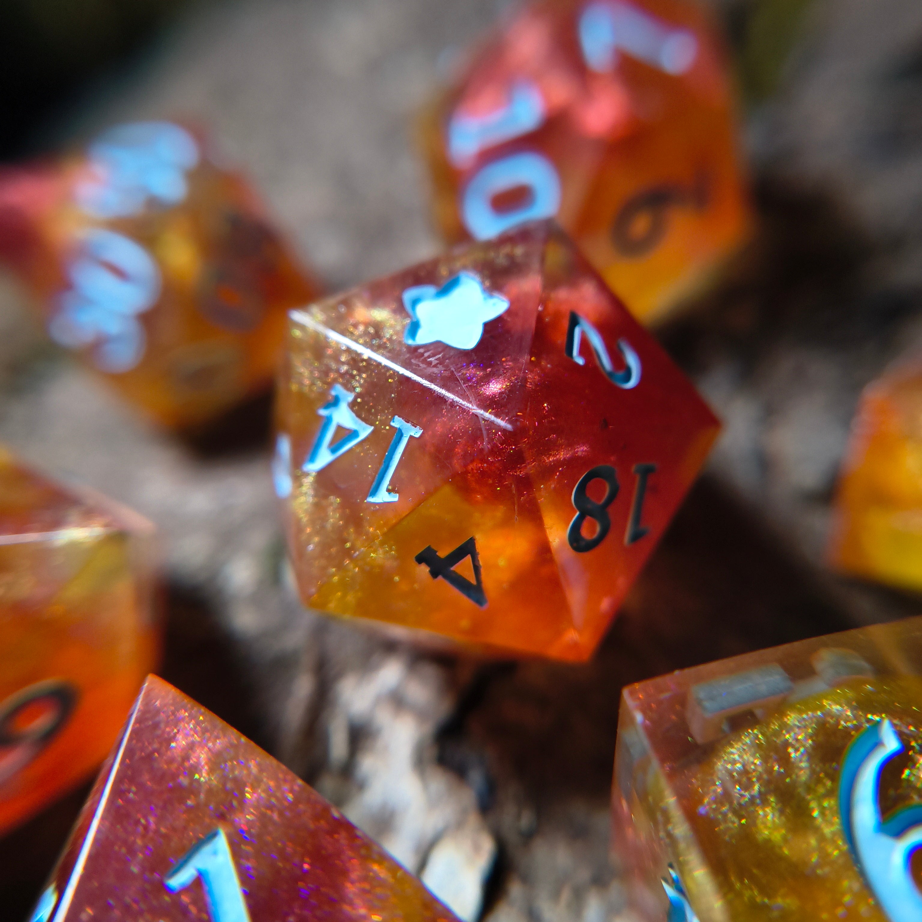 Close-up of of fiery polyhedral dice on a wood surface